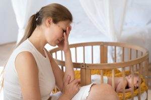 post-pregnancy depression faced by a lady sitting depressed